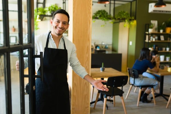 Yuba city café owner welcomes customers into the café. The business is protected by Rodent Wrangler's commercial pest control service